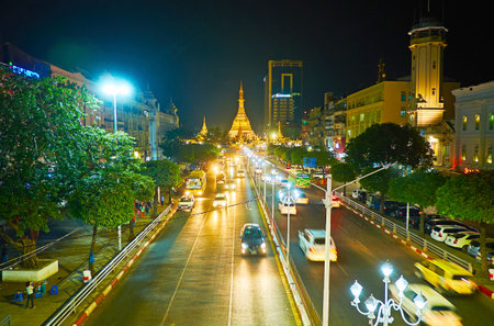 Evening traffic along Sule road, located in Downtown, the giant golden Sule Pagoda is seen on background,  Yangon, Myanmar.のeditorial素材