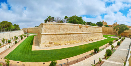 Panorama of medieval Mdina fortress with preserved huge bastions, massive walls and ornamental garden in moat, Malta.のeditorial素材