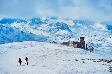 Snowshoeing is popular activity on Dachstein-Krippenstein, its large territory, numerous landmarks and viewpoints attract people to walk among the snowy vastness, Salzkammergut, Austriaの写真素材
