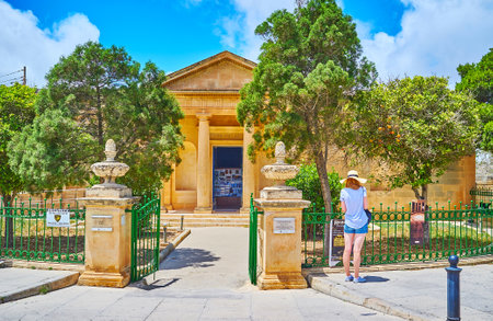 RABAT, MALTA - JUNE 16, 2018: The facade of antique Domus Romana (Roman House) museum, hidden behind the lush trees of garden, on June 16 in Rabat.のeditorial素材