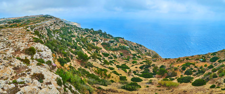 The fast low clouds and fog along Mediterranean coast at the Dingli Cliffs, Siggiewi, Northern Region of Malta.の写真素材
