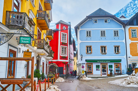 HALLSTATT, AUSTRIA - FEBRUARY 25, 2019: The pleasant walk along the scenic Market square (Marktplatz) bwith colorful housing, cozy cafes and restaurants, on February 25 in Hallstatt.のeditorial素材