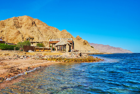 The red rocks of Sinai desert stretch along the shore of Aqaba gulf, Dahab, Egypt.の写真素材