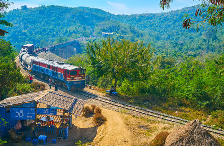 HEHO, MYANMAR - FEBRUARY 19, 2018: The old train rides along the old arch Bawa Than Tha Yar Bridge, stretching over the deep gorge in mountains of Shan State, on February 19 in Heho.のeditorial素材