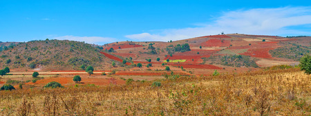 Panoramic scenery of Heho farmlands with bright red plowed soil, Myanmar.