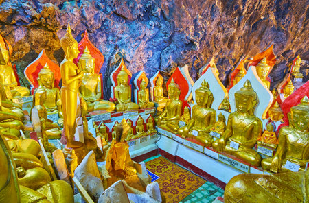 PINDAYA, MYANMAR - FEBRUARY 19, 2018: The small prayer area in large hall of Pindaya cave, surrounded by gilded Buddha statues, on February 19 in Pindayaのeditorial素材