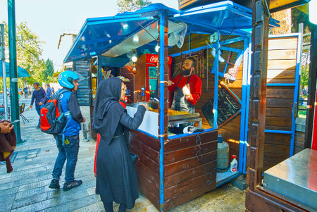 TEHRAN, IRAN - OCTOBER 25, 2017: The fast food stalls and trucks in 30 Tir street are popular among...