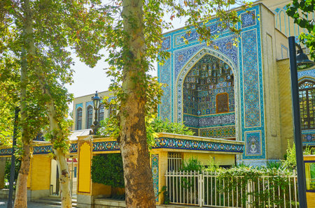 The view on the tile portal of Malek museum with ornate patterns and carved muqarnas arch through...