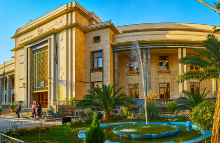 TEHRAN, IRAN - OCTOBER 25, 2017: The beautiful garden in front of the National Museum with lush palm trees, flower beds and fountainsのeditorial素材