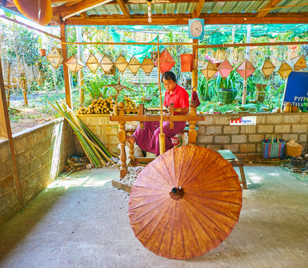 PINDAYA, MYANMAR - FEBRUARY 19, 2018:  Visit cottage paper umbrella workshop and watch the process of umbrella makingのeditorial素材