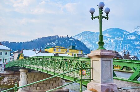 The scenic vintage streetlight at the pedestrian entrance to the lacelike Elizabethbrucke (Kaiserin Elizabeth bridge) over the Traun river, Bad Ischl, Salzkammergut, Austria.の写真素材