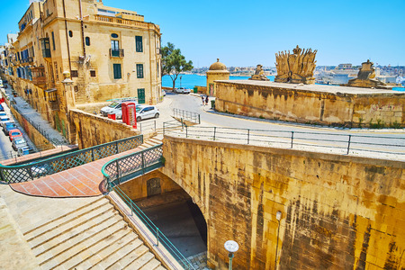 The small pedestrian bridge connects St Ursula street with upper level of Victoria gate - the part of the medieval Valletta fortiications, Malta.の写真素材