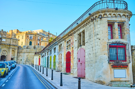 The line of old warehouses in Liesse street with colorful wooden doors, nowadays these objects serve as stores, small cafes, repair shops, Valletta, Maltaの写真素材