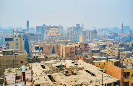 The dusty rooftop yards of Islamic Cairo with heaps of waste and shabby walls, Egyptの写真素材