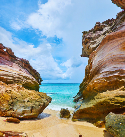 The red rocks on the shore of Khai Nai island boasts the unique shape, created by weathering, Phuket, Thailandの写真素材