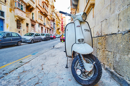 VALLETTA, MALTA - JUNE 19, 2018: The white vintage moped Lambretta Jet 200 is parked in old town street, on June 19 in Valletta.のeditorial素材