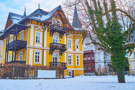 The colorful edifice, decorated with carved wooden balconies, located in Kurhausstrasse, Bad Ischl, Salzkammergut, Austriaのeditorial素材