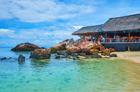 PHUKET, THAILAND - MAY 1, 2019: The old wooden hut on the shore of Khai Nai island neighbors with the huge boulders and rocks, on May 1 on Phuketのeditorial素材