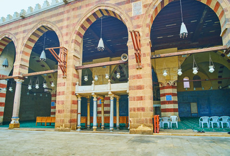 CAIRO, EGYPT - DECEMBER 22, 2017: Unique style of Aqsunqur (Blue) Mosque with Ablaq (striped) details of red and yellow stone, carved dikka and the fine white-blue pattern on tile walls, on December 22 in Cairoのeditorial素材