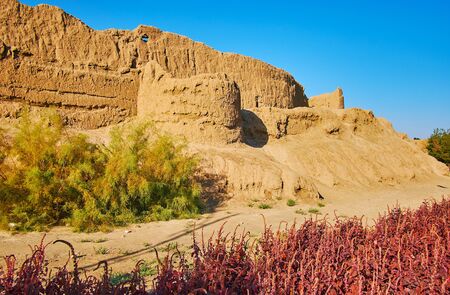 The ancient ruins of mud wall of Ghal'eh Jalali fortress, surrounded by plants of Mellat park,...