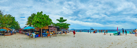 PHUKET, THAILAND - MAY 1, 2019: Panorama of the sandy beach of Khai Nok island with a view on huts of food court, on May 1 on Phuketのeditorial素材