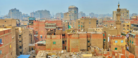 Panorama of dense shabby high-rises in overpopulated Al-Sayeda Zeinab district of Cairo with garbage and numerous satellite dishes on the rooftops, Egyptのeditorial素材