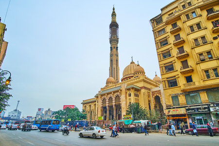 CAIRO, EGYPT - DECEMBER 22, 2017: The scenic building of El Fath Mosque with tall minaret, carved dome, slender pillars and numerous arches is seen behind the traffic in Ramses street, on December 22 in Cairo.のeditorial素材