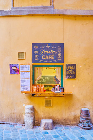 VIENNA, AUSTRIA - FEBRUARY 18, 2019: The small window of famous Fenster Cafe, that offers variety of hot beverages, located in medieval building in historical Greek Quarter, on February 18 in Vienna.のeditorial素材