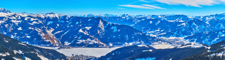 Aerial panorama of Zeller see lake  highland valley, surrounded by rocky mountains, covered with snow, Schmitten mount, Zell am See, Austriaのeditorial素材