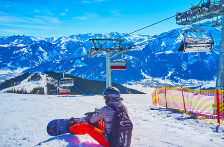 ZELL AM SEE, AUSTRIA - FEBRUARY 28, 2019: The winter Alpine scenery with riding skilift, gentle...