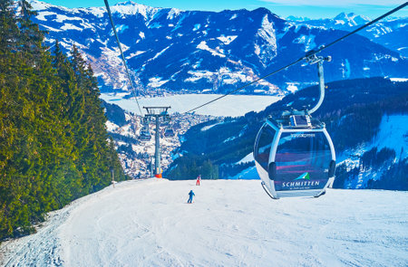 ZELL AM SEE, AUSTRIA - FEBRUARY 28, 2019: The scenic mountain landscapes from the Trassxpress cableway, riding along the snowy slope of Schmitten mount, on February 28 in Zell Am Seeのeditorial素材