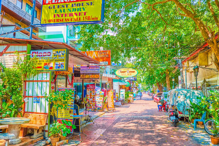 BANGKOK, THAILAND - APRIL 22, 2019: The narrow shady street with numerous restaurants, shops, hotels and travel agencies is an absolutely empty during day heat, on April 22 in Bangkokのeditorial素材