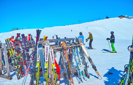 ZELL AM SEE, AUSTRIA - FEBRUARY 28, 2019: The ski stands in front of the Schmitten mountain slope...