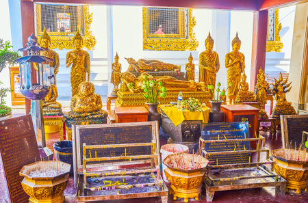 BANGKOK, THAILAND - APRIL 22, 2019: The Altar with sculptures of Lord Buddha and candle holder stands in front, on April 22 in Bangkokのeditorial素材
