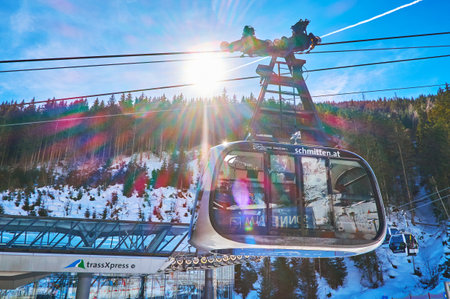 ZELL AM SEE, AUSTRIA - FEBRUARY 28, 2019: The futuristic air tram of Porsche Design Schmittenhohenbahn in bright sun rays, on February 28 in Zell Am See.のeditorial素材