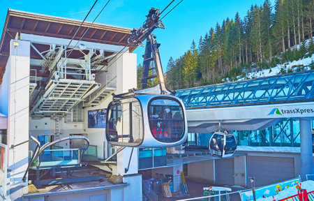 ZELL AM SEE, AUSTRIA - FEBRUARY 28, 2019: The lower station of Schmittenhohebahn located next to the Trassxpress station at the foot of Schmitten mount, on February 28 in Zell Am Seeのeditorial素材