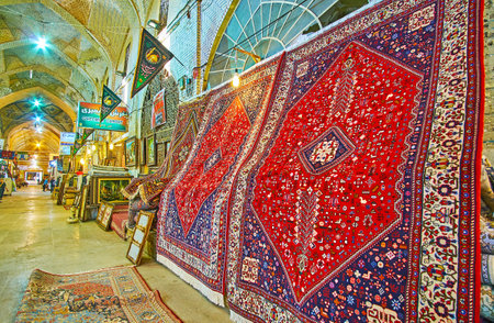 SHIRAZ, IRAN - OCTOBER 14, 2017: The  carpet section of Vakil Bazaar with beautiful kilims, decorated with colorful Persian patterns, on October 14 in Shiraz.のeditorial素材
