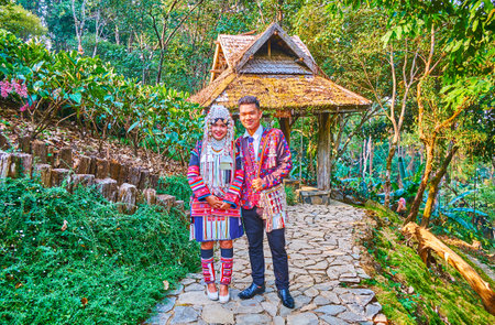 CHIANG RAI, THAILAND - MAY 9, 2019: The wedding couple of Akha Hill Tribe poses for the picture in...