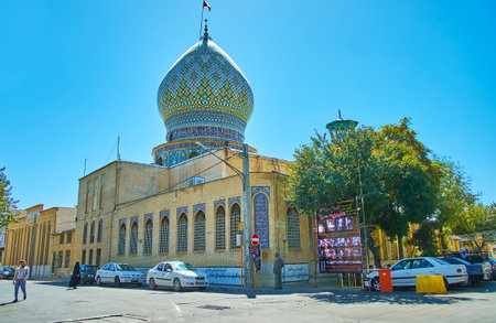 SHIRAZ, IRAN - OCTOBER 14, 2017: The brick building of Ali Ibn Hamzeh Holy Shrine with ornate tile...