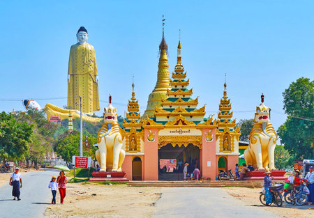 MONYWA, MYANMAR - FEBRUARY 22, 2018: The entrance gate of Aung Sakkya Pagoda of Maha Bodhi Ta Htaung monastery with chinthe (lion) statues, Aung Sakkya Pagoda and Buddha statues on background, on February 22 in Monywaのeditorial素材