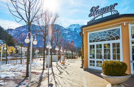 BAD ISCHL, AUSTRIA - FEBRUARY 26, 2019: Snowy Esplanade park, located on the bank of Traun river, is nice place for the day walk, on February 26 in Bad Ischl.のeditorial素材