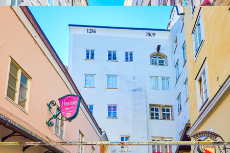SALZBURG, AUSTRIA - FEBRUARY 27, 2019: The narrow passage in Altstadt with arched balconies of medieval houses, on February 27 in Salzburgのeditorial素材