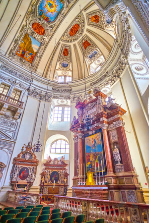 SALZBURG, AUSTRIA - FEBRUARY 27, 2019: The large Chancel with stone Altar and beautifully decorated half-dome of the Apse, on February 27 in Salzburgのeditorial素材