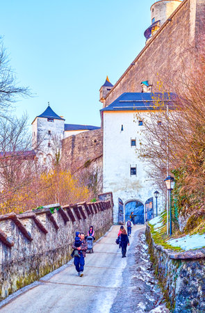 SALZBURG, AUSTRIA - FEBRUARY 27, 2019: The hilly ascent to the Hohensalzburg citadel with huge defensive Keutschach Gates on the top, on February 27 in Salzburgのeditorial素材