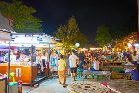 CHIANG MAI, THAILAND - MAY 2, 2019: The lounge zone of Ploen Ruedee Night Market with tables of wire reels and chairs amid the food stalls, on May 2 in Chiang Maiのeditorial素材