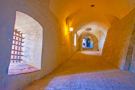 SALZBURG, AUSTRIA - FEBRUARY 27, 2019: The long corridor with massive stone supports and large windows with old grilles, Hohensalzburg Castle, on February 27 in Salzburgのeditorial素材