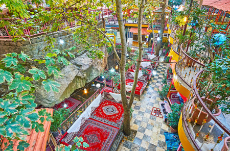 The valley of Darband river, stretching along the rocky gorge, is occupied with many restaurants, cafes and outdoor lounge zones with trestle-beds and tables under the shady trees, Tehran, Iranのeditorial素材