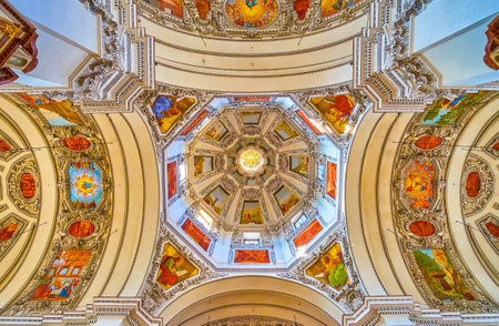 SALZBURG, AUSTRIA - FEBRUARY 27, 2019: The dome and the cruciform part of Salzburg Cathedral with extraordinary combination of colorful frescoes and white carved plaster, on February 27 in Salzburgのeditorial素材