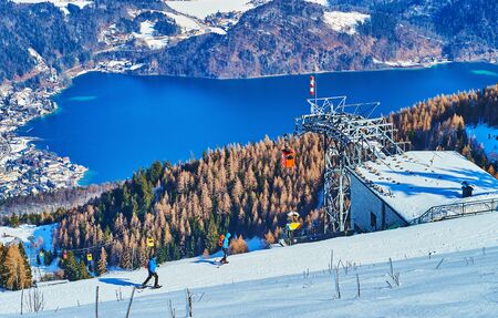 Zwolferhorn mount is the nice place to watch amazing clear Wolfgangsee lake, seen in valley behind the spruce forests and cable car, St Gilden, Salzkammergut, Austriaの写真素材