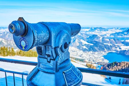 The viewpoint of Zwolferhorn mount is equipped with coin-operated telescope (tower viewer), showing Wolfgangsee valley, lake, St Gilden town, mountains of Salzkammergut, Austriaの写真素材